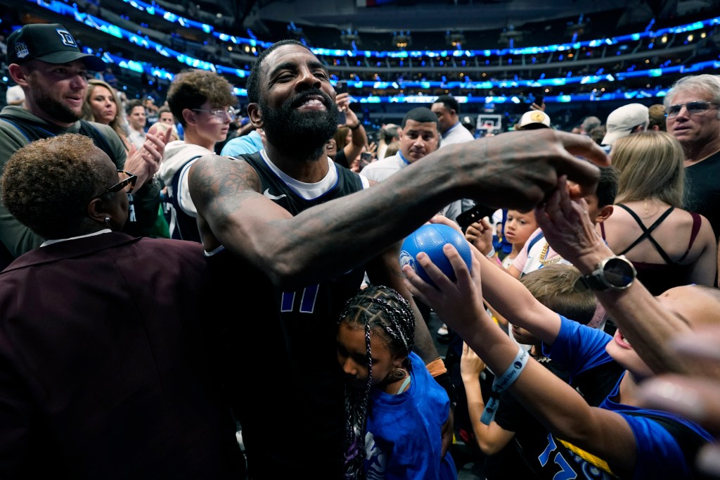 Kyrie Irving celebrates with the fans after the Mavericks' series-clinching win.