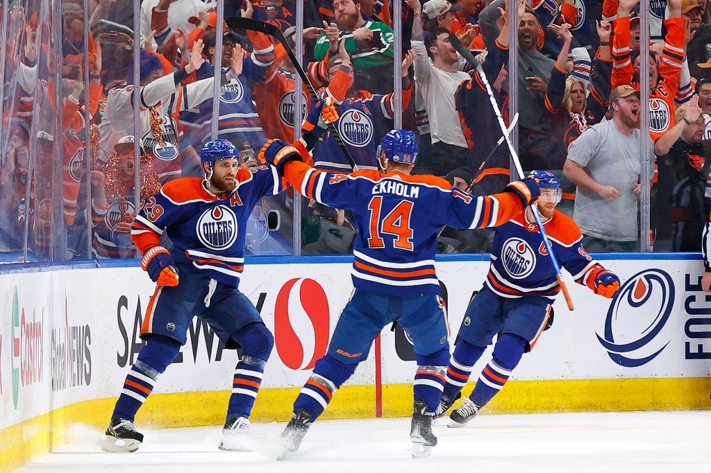 Leon Draisaitl (left) celebrates his second period goal with teammates during the Oilers' 5-2 win over the Stars in Game 4 of their Western Conference Final series.