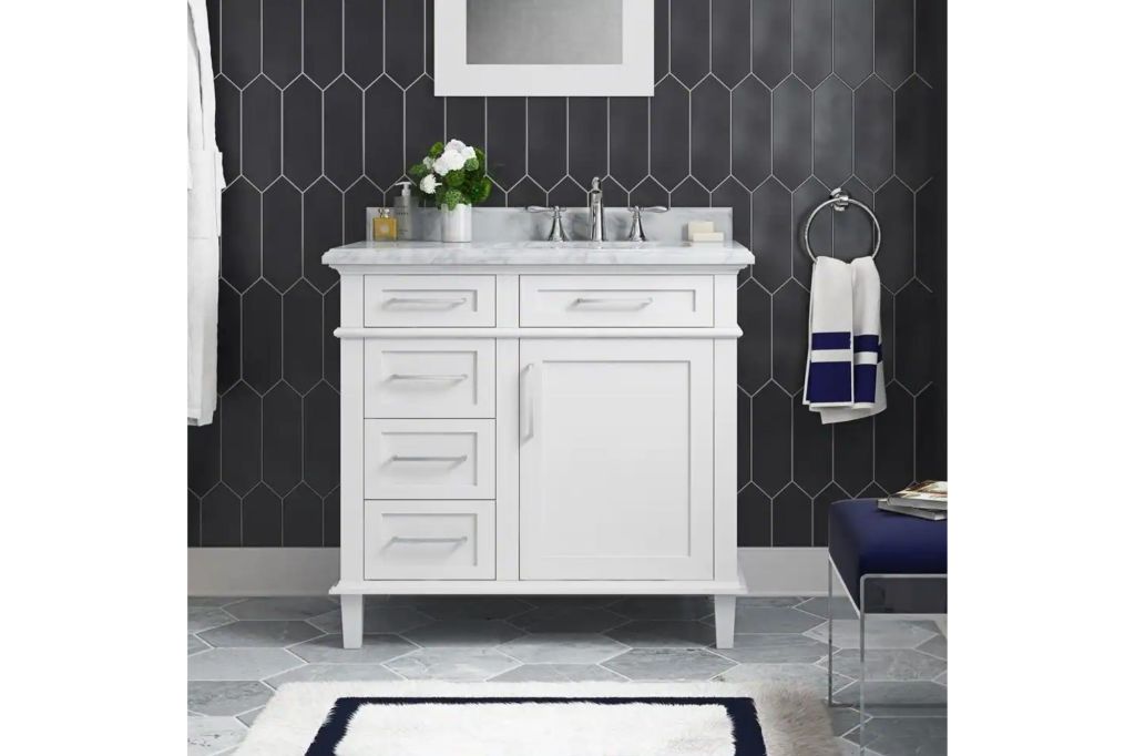 A bathroom with a white sink and black subway style wall.