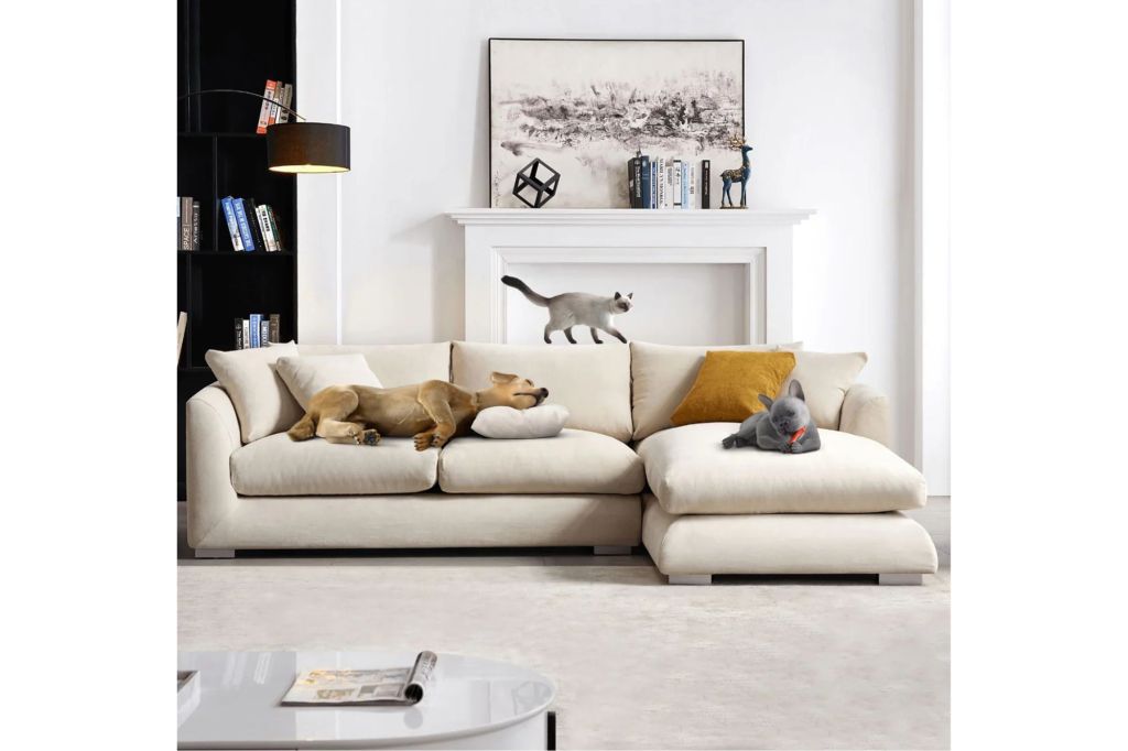 A sectional couch with animals resting on top of it.