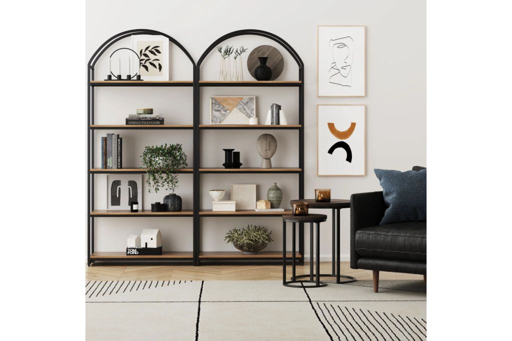 Two arched bookcases in a living room.