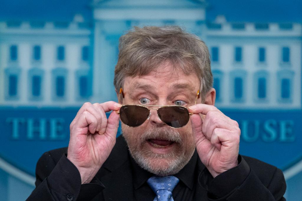 Actor Mark Hamill takes off sunglasses given to him by President Joe Biden, as he joins White House press secretary Karine Jean-Pierre as she speaks with reporters in the James Brady Press Briefing Room at the White House, Friday, May 3, 2024, in Washington.