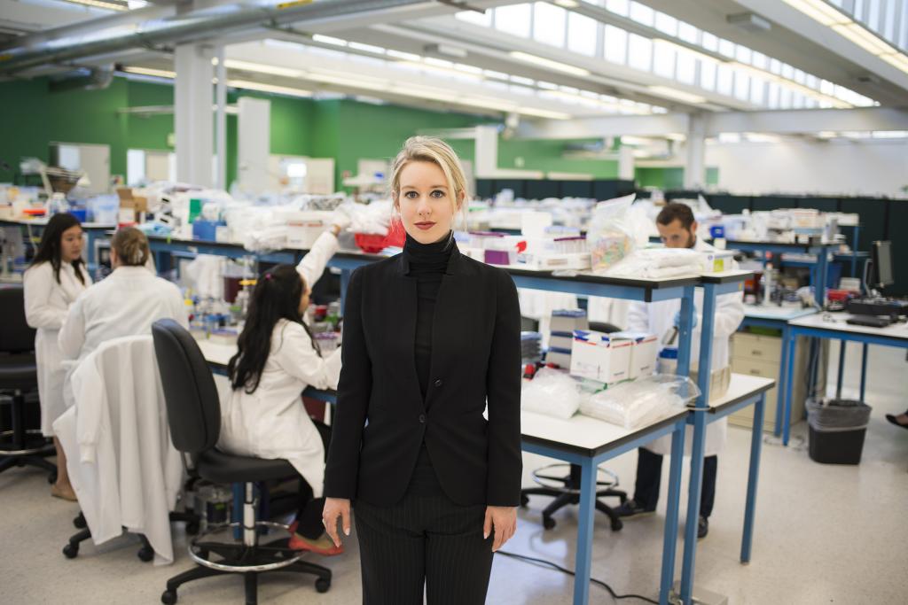 Elizabeth Holmes stands in a lab