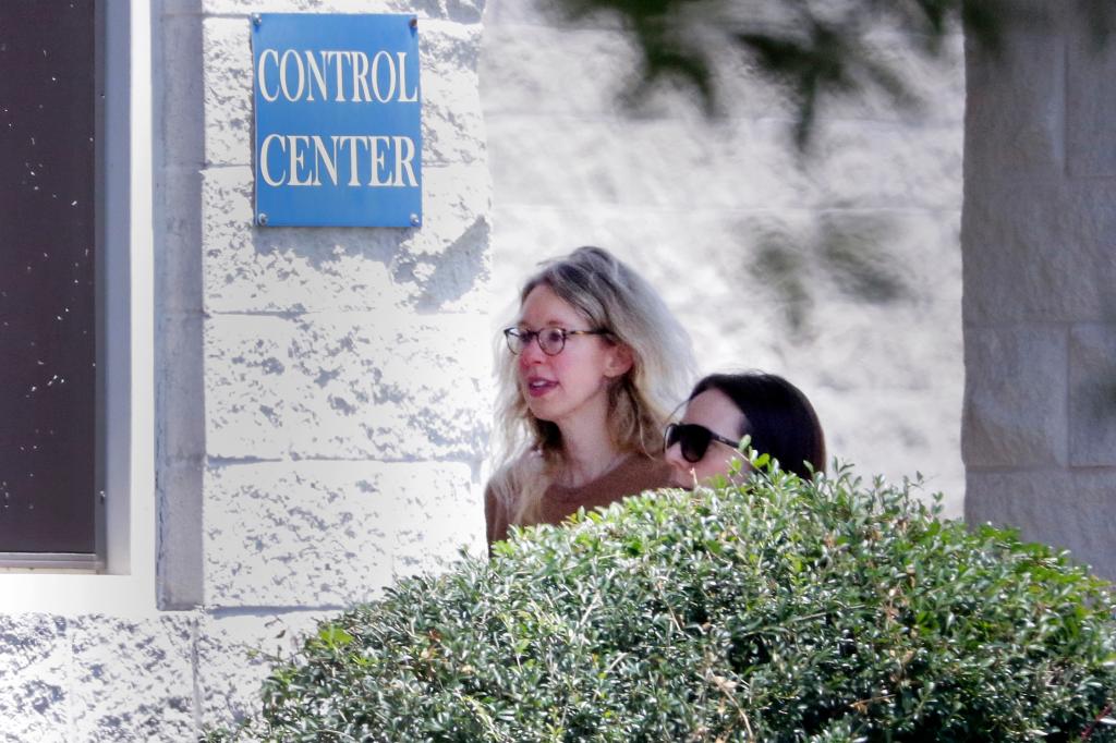 Disgraced Theranos CEO Elizabeth Holmes being escorted by prison officials into a federal women's prison camp in Bryan, Texas