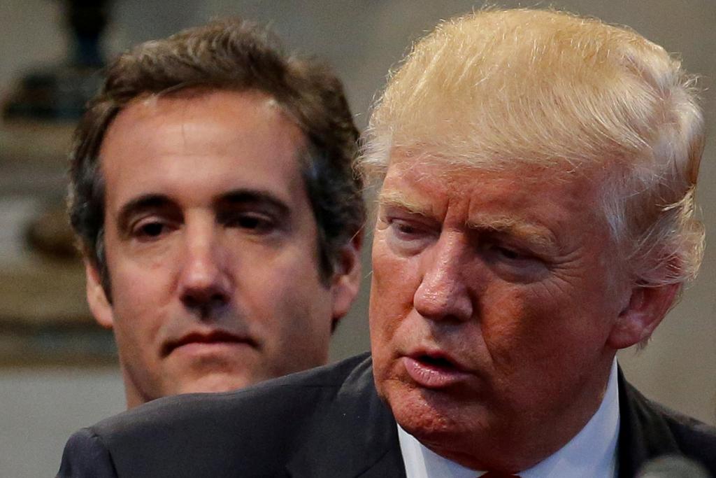 Donald Trump's personal attorney Michael Cohen standing behind Trump while group of supporters pray over him during a campaign stop at the New Spirit Revival Center church.