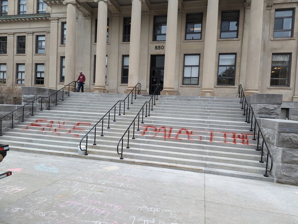 Protesters at the University of Ottawa wrote "Free Palastine" on the steps to Tabaret Hall.