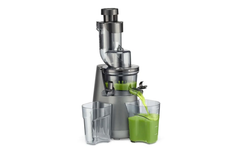 A juicer with green juice in it