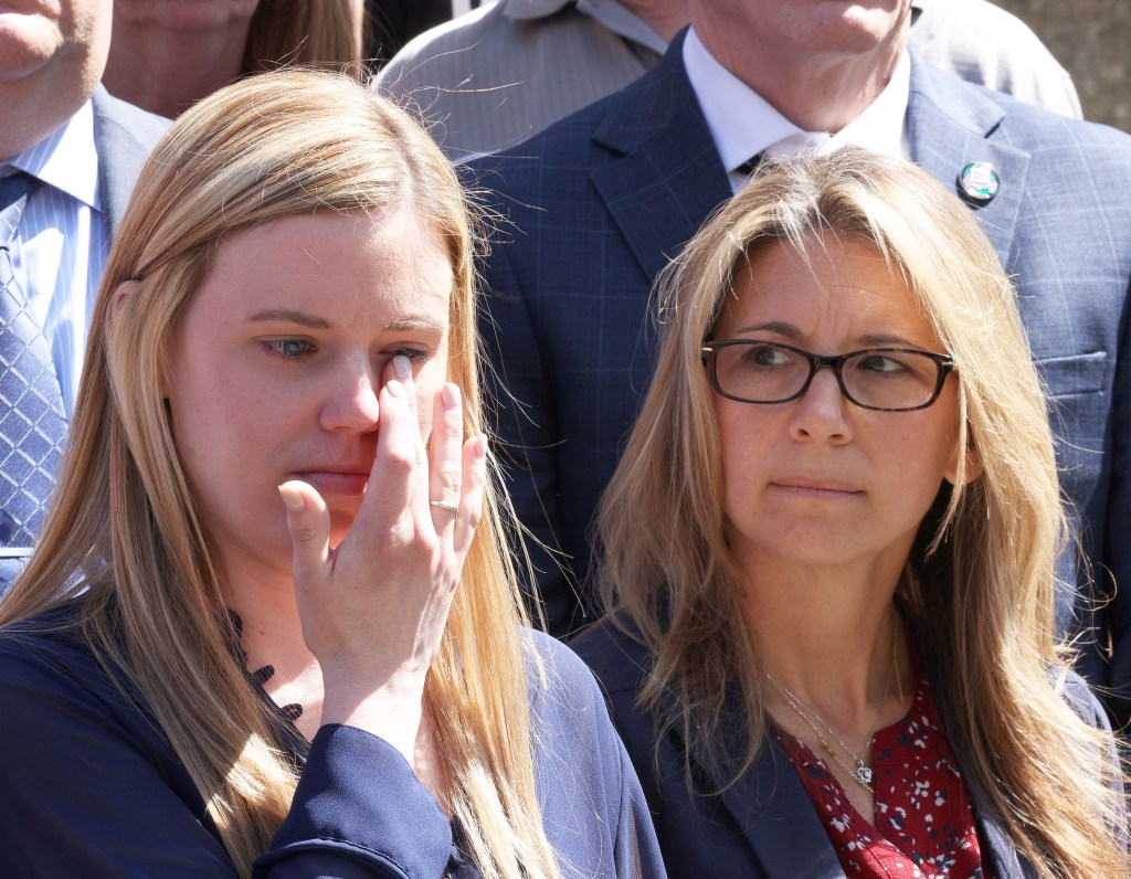 Diller's widow Stephanie wiping away tears at a press conference after the arraignment.