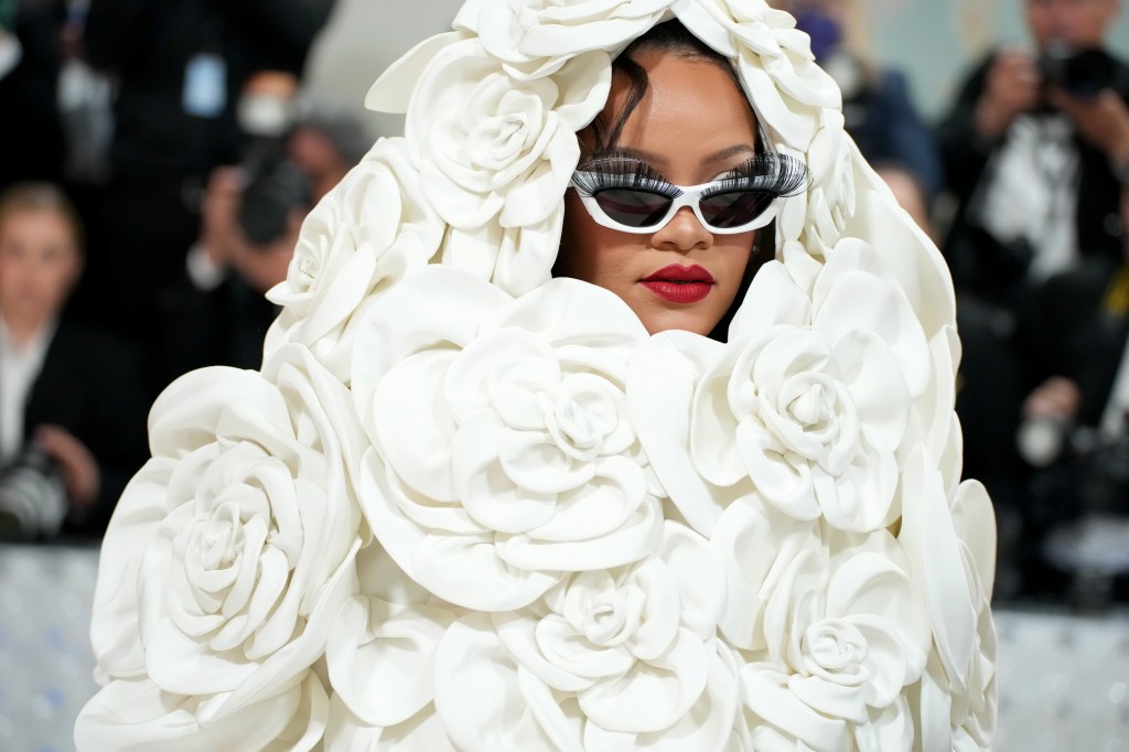 rihanna in a white valentino gown of large roses at met gala