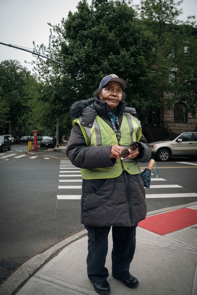 Maggie Poston stands on a Park Slope corner in yellow crossing guard vest. 