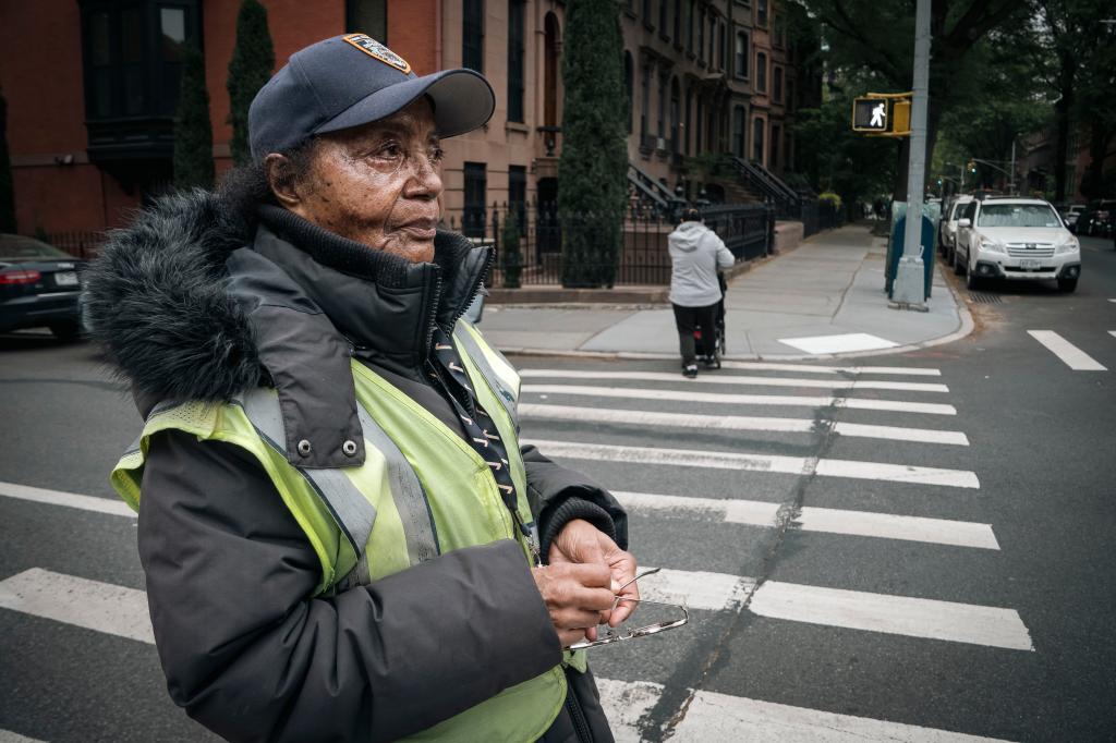 Maggie Poston standing in profile in a Park Slope crosswalk. 