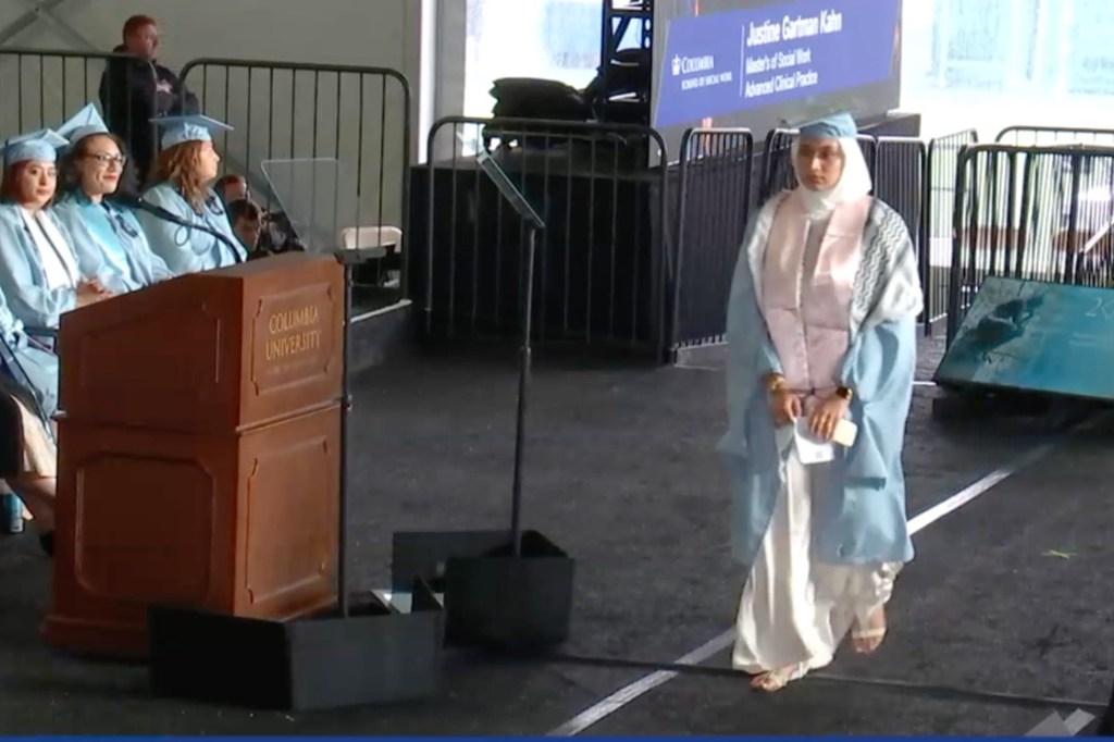 A stone-faced Maliha Fairooz walked the stage with her handcuffed hands in front of her.