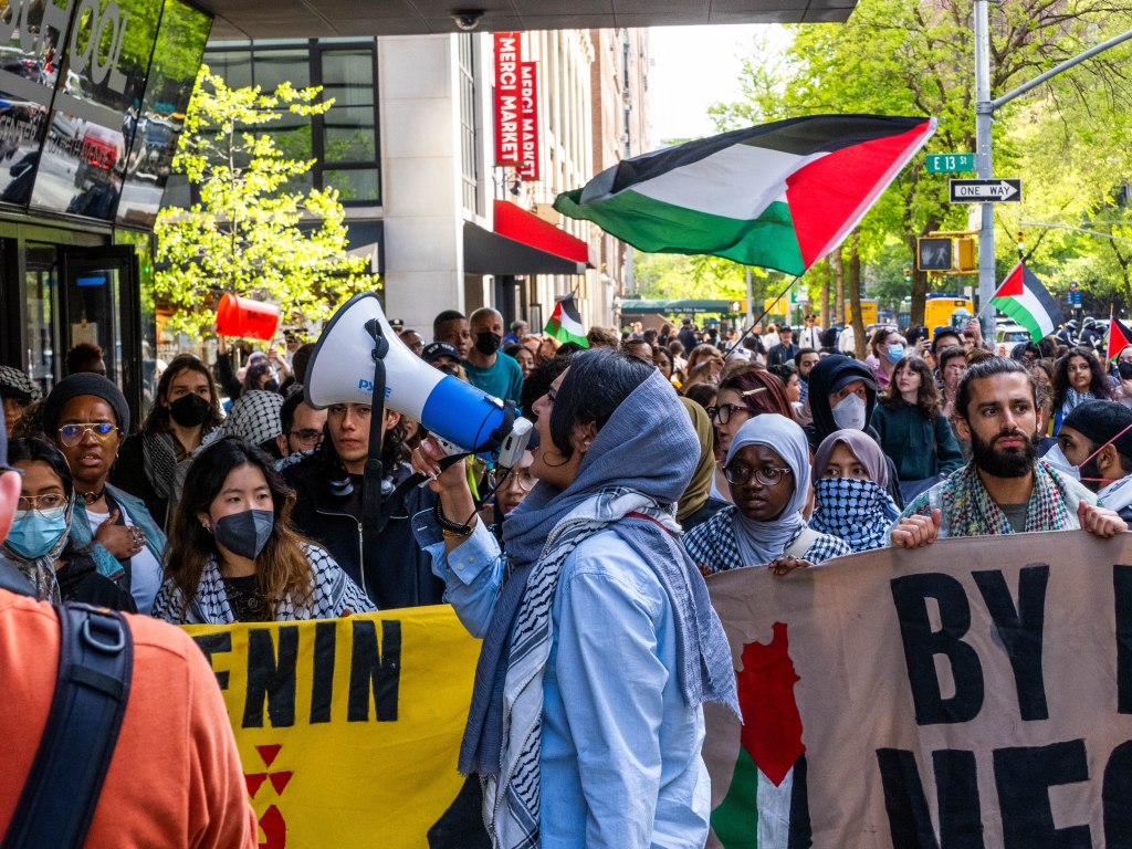 Anti-Israel protesters waving Palestinian flags and marching en masse along University Place in Manhattan. 