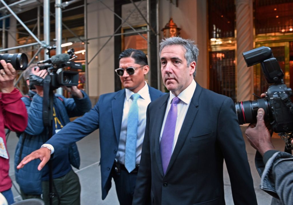 Michael D. Cohen in a suit and tie leaving his apartment, heading towards NY Criminal Court.