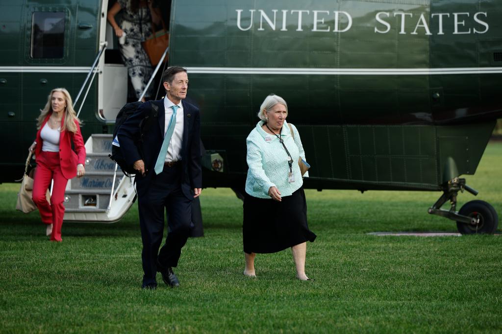 Senior Advisor to the President for Communications Anita Dunn walks across the South Lawn after returning to the White House.