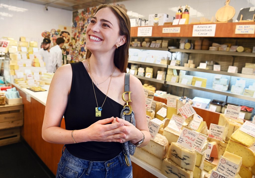 Cojab smiling while surrounded by cheese