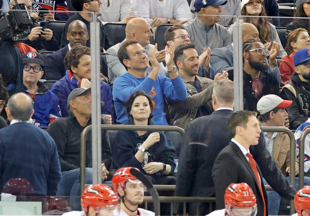 Actor Will Arnett claps as he cheers in the first period