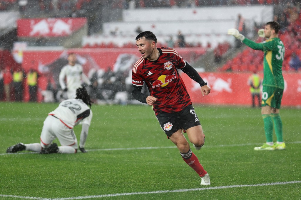 New York Red Bulls midfielder, Lewis Morgan, celebrating after scoring a goal against FC Dallas in a soccer match at Red Bull Arena