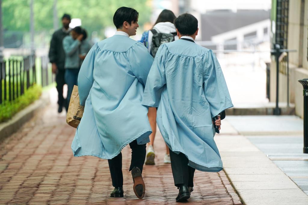 Columbia students in graduation gowns arrive on campus on May 6, 2024.