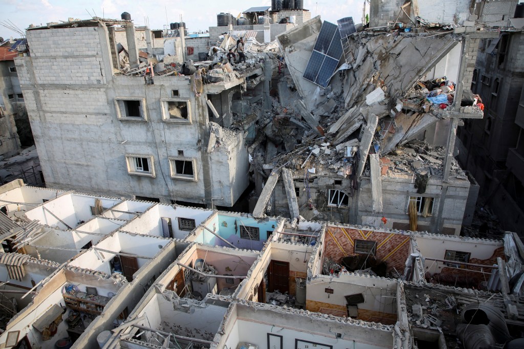 Palestinians inspect the site of an Israeli strike on a house, amid the ongoing conflict between Israel and the Palestinian Islamist group Hamas, in Rafah, in the southern Gaza Strip May 7, 2024.