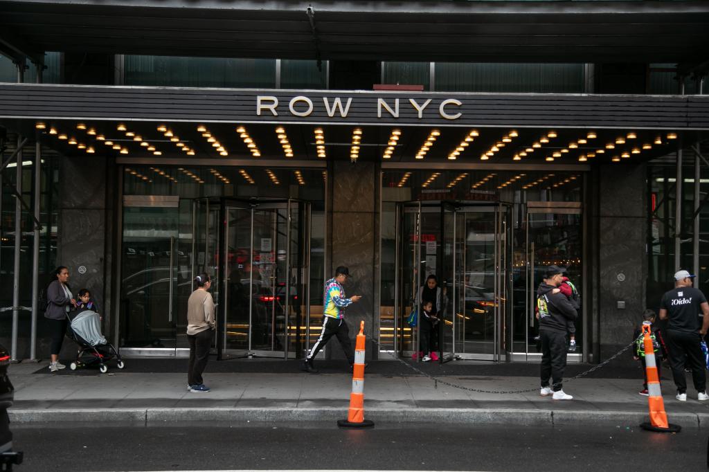 Pedestrians in front of the Row Hotel, currently a migrant shelter, in the Times Square neighborhood of New York City on Friday, May 10, 2024. 