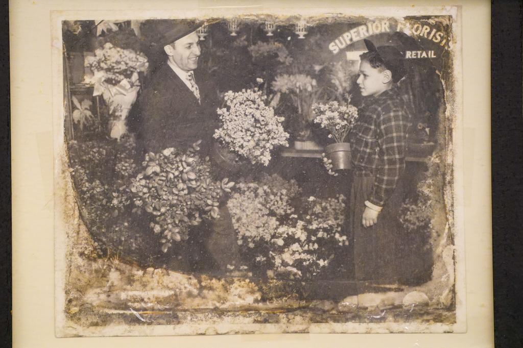 This photo was taken when Sam Rosenberg, now age 86 owner of Superior Florist Ltd. was age 9 standing with his father named Louis in front of their shop. 