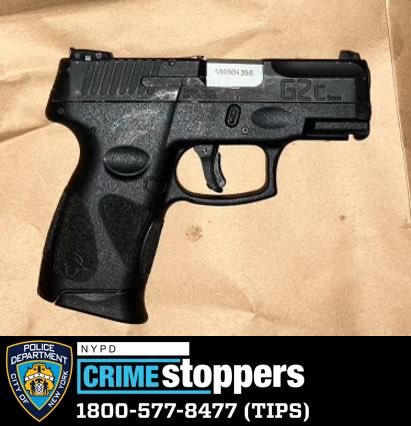 A black firearm recovered by the NYPD from an incident in East Flatbush, Brooklyn, resting on a brown surface.