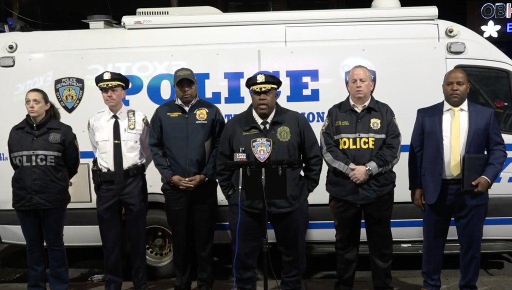 Group of police officers standing in front of a white van in Brooklyn, NYC