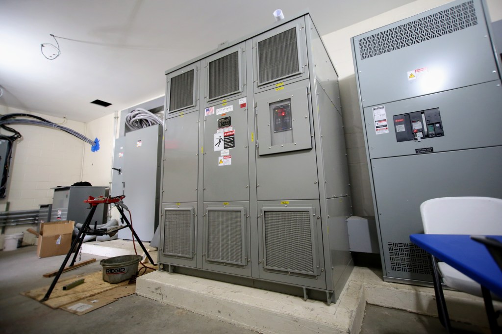 Large grey cabinet in a room showing post-flood upgrades at a zoo.