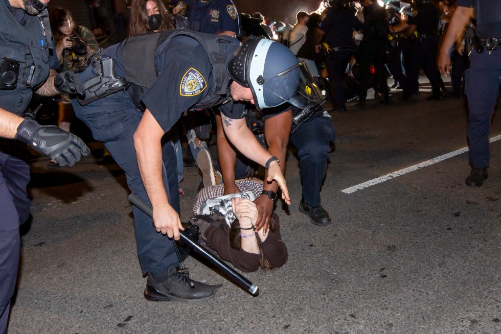 NYPD officers detain a protester outside FIT in Manhattan on May 7 2024.