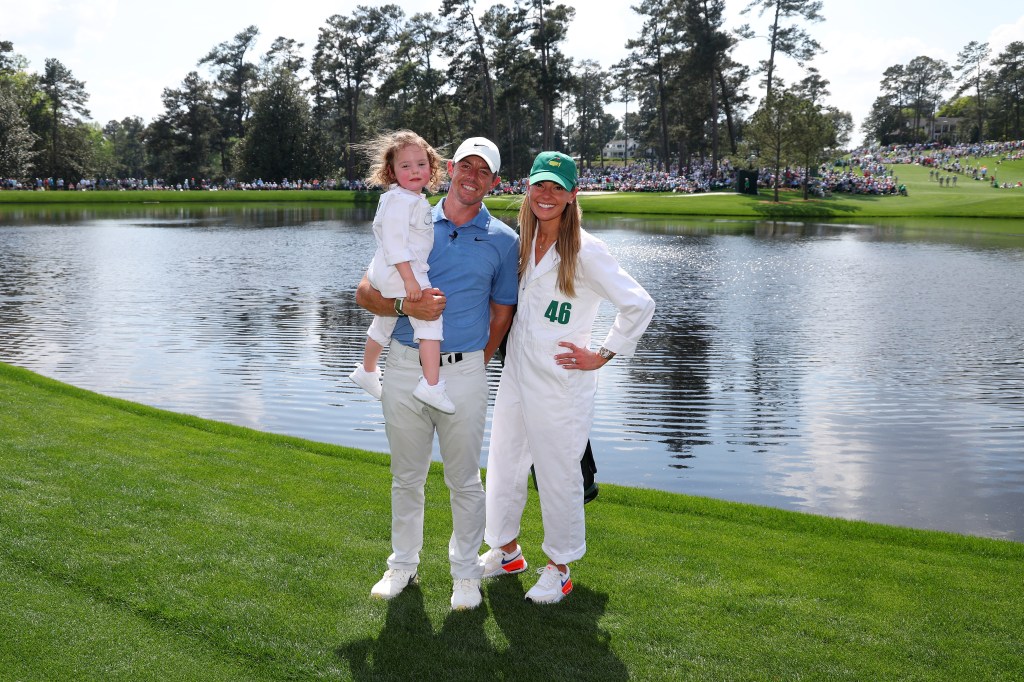 Rory McIlroy poses for a photo with his wife, Erica Stoll and daughter Poppy McIlroy during the Par 3 contest prior to the 2023 Masters.