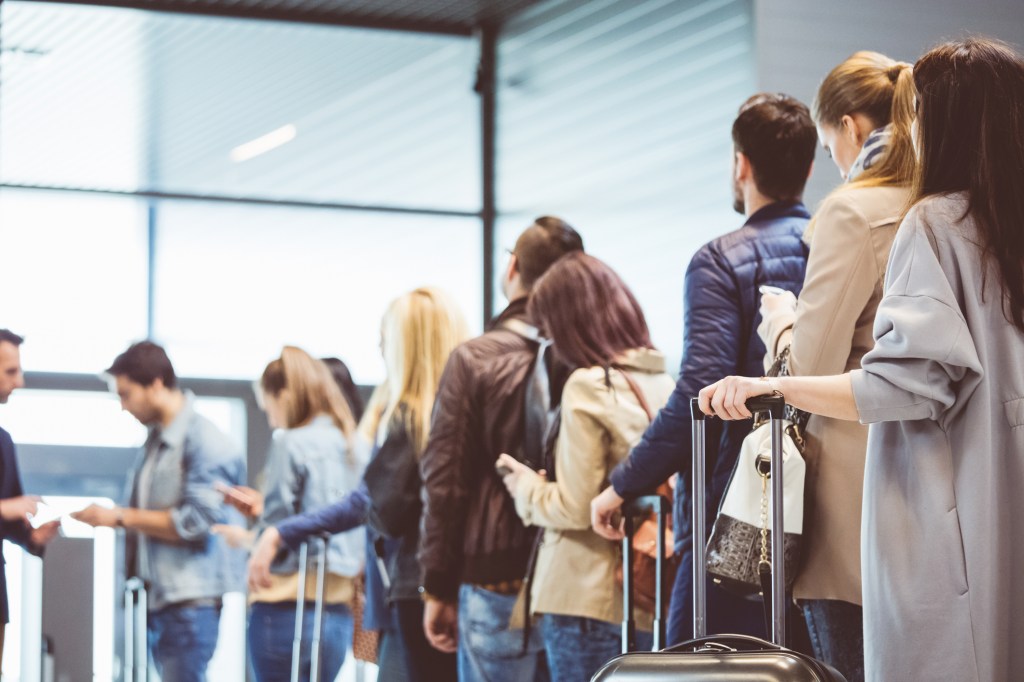 People waiting in line to board a plane.