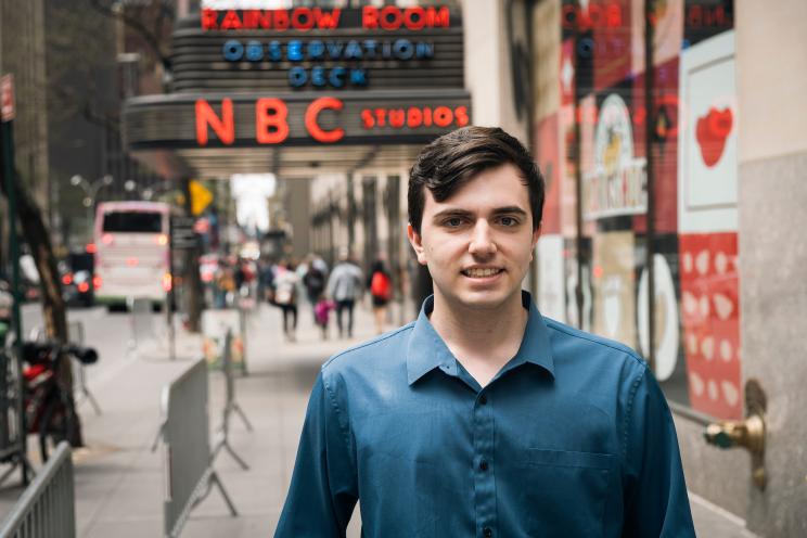 A journalism intern named Sky Crabtree standing in front of a sign at WNBC at 30 Rockefeller center in Manhattan, NY