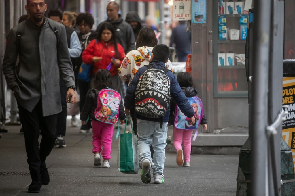 Students leave the Row Hotel, currently a migrant shelter, in the Times Square neighborhood of New York City on Friday, May 10, 2024. 