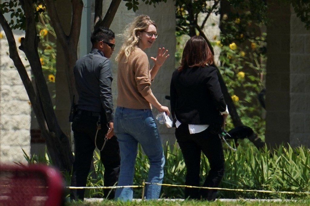 Elizabeth Holmes, founder of Theranos, waving as she arrives at the Federal Prison Camp in Bryan, Texas to begin her prison sentence