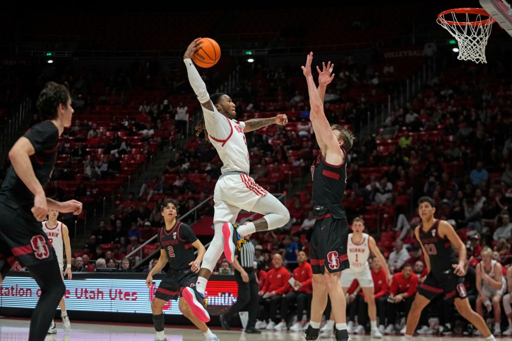 Utah guard Deivon Smith goes to the basket as Stanford guard Michael Jones defends.