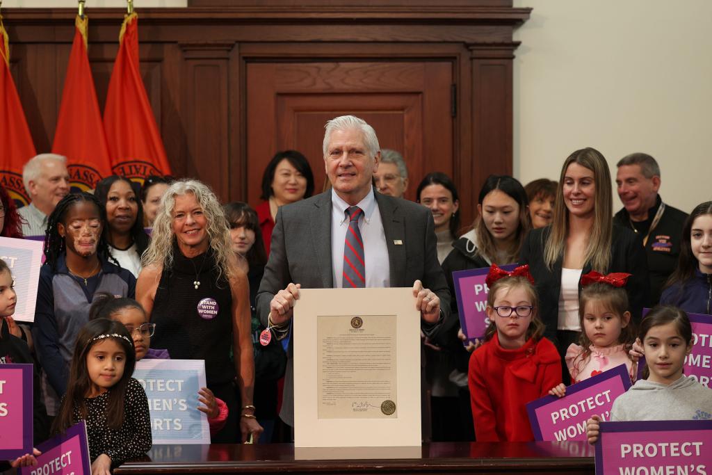 Nassau County Executive Bruce Blakeman holding Executive Order at a press conference, surrounded by children, in the Theodore Roosevelt Building, Long Island, NY