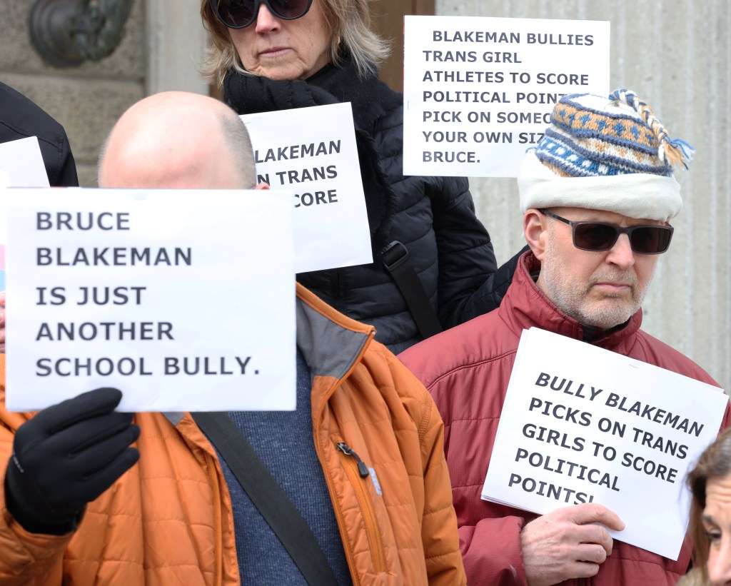 Supporters with Juli Grey-Owens, Executive Director of Gender Equality New York, protesting outside the Theodore Roosevelt Building in Mineola, Long Island, NY.