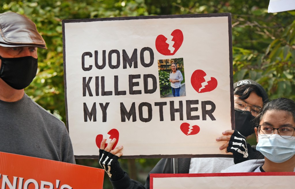 Several dozen people who lost loved ones in nursing homes during the early months of the COVID - 19 pandemic gathered in front of the Cobble Hill Health Center to demand an apology from Governor Cuomo.