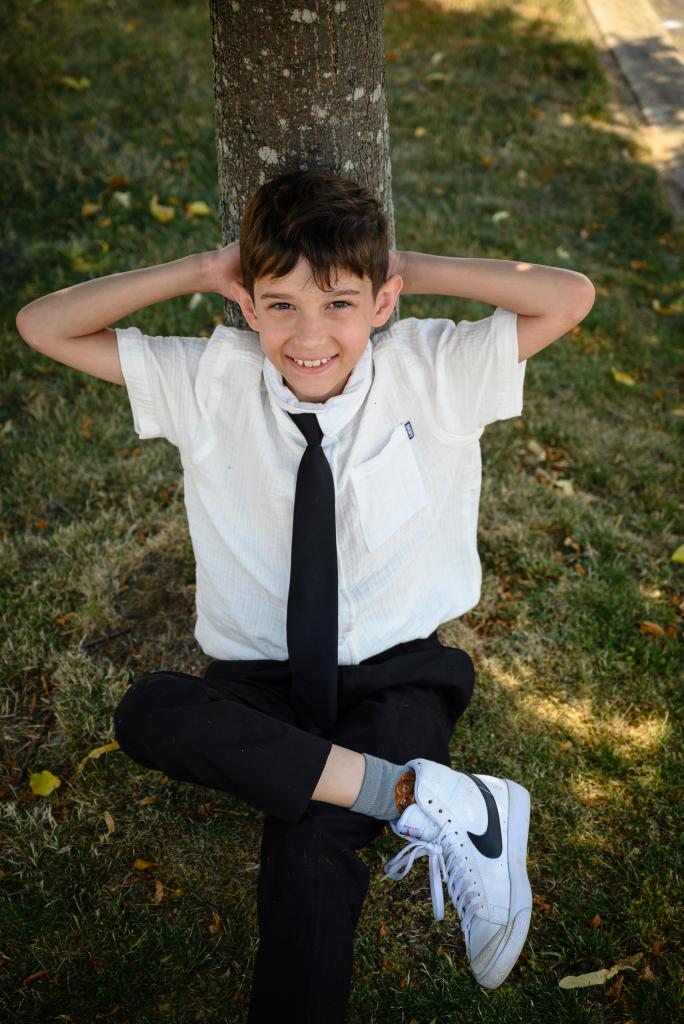 11-year-old Joe Petraro laying against a tree