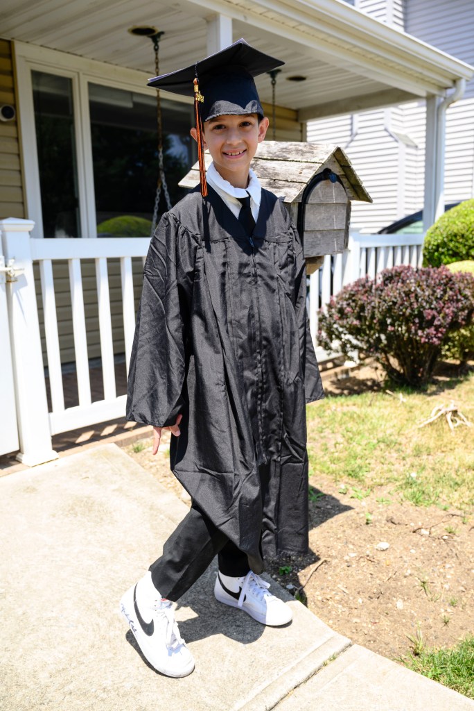 11-year-old Joe Petraro wearing a cap and gown. 