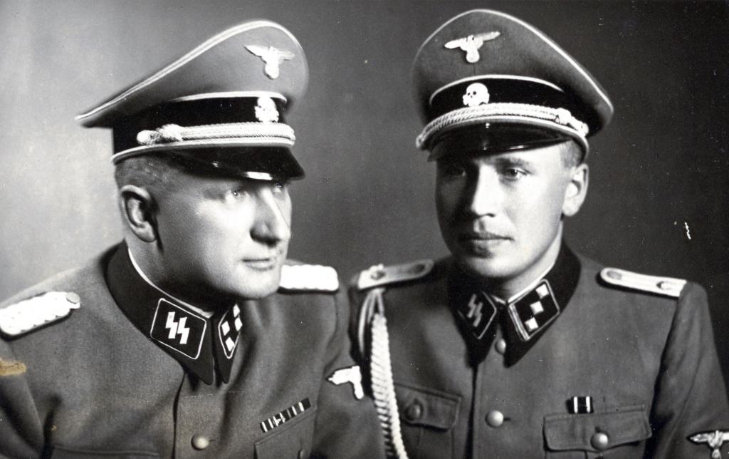 The very first photograph in the photograph album is a double portrait of Richard Baer (on left), the last Auschwitz camp commandant between 1944 and 1945, and Baer's adjutant, Karl Höcker. A chilling photo album shows Nazis at Auschwitz enjoying blueberries and sunbathing in deckchairs. The candid moments were captured on camera as 1.1 million people were murdered at the death camp. The album was found by an unnamed American counterintelligence officer who was billeted in Frankfurt after Germany's surrender in 1945. The photos are now the subject of a play that opened last month off-broadway, the 2024 Pulitzer Prize for Drama finalist Here There Are Blueberries. The play dramatises the work of the curators who examined the mysterious album featuring the Nazi-era photographs that arrived at the desk of a U.S. Holocaust Memorial Museum (USHMM) archivist in 2007. The album consists of 116 photographs taken during the last six months of Auschwitz, between June 1944 and January 1945. The album shows Auschwitz during its most lethal period, coinciding with the murder of 400,000 Hungarian Jews.