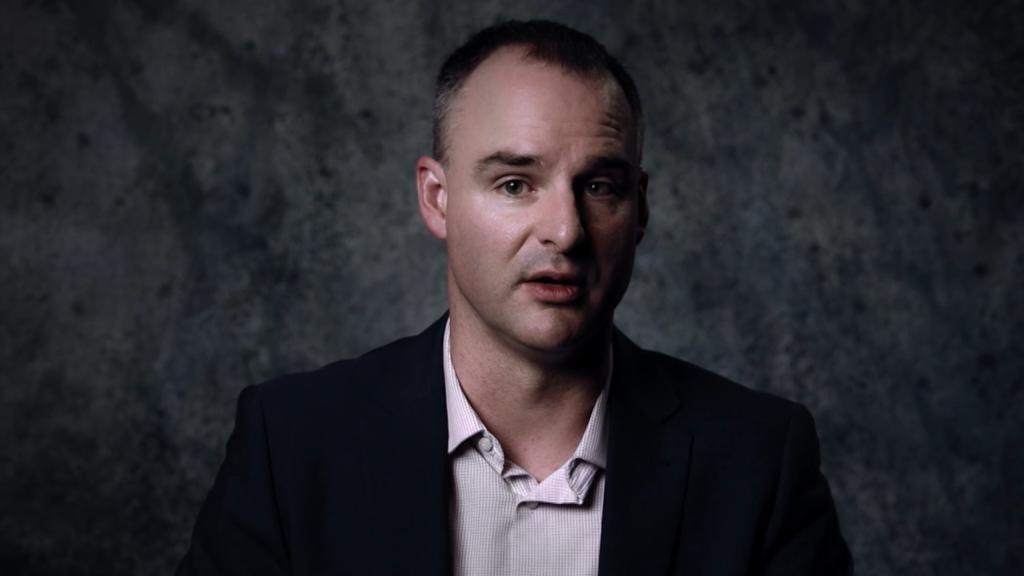 Ben Shenton, a survivor of The Family cult in Melbourne, dressed in a suit, symbolizing his triumphant overcoming of past trauma.