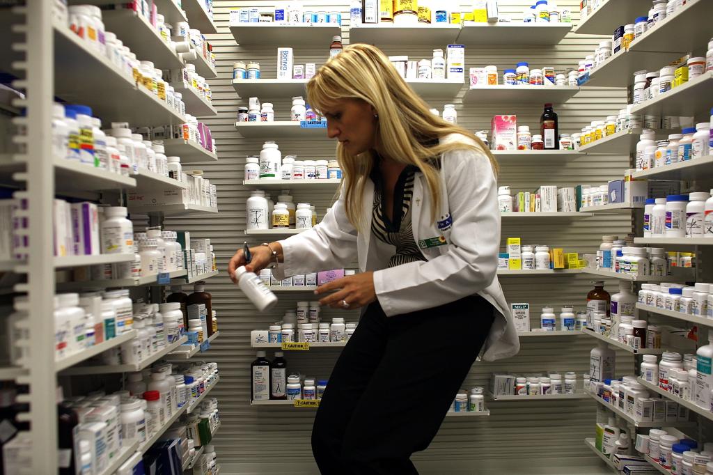 Pharmacist checks over prescriptions