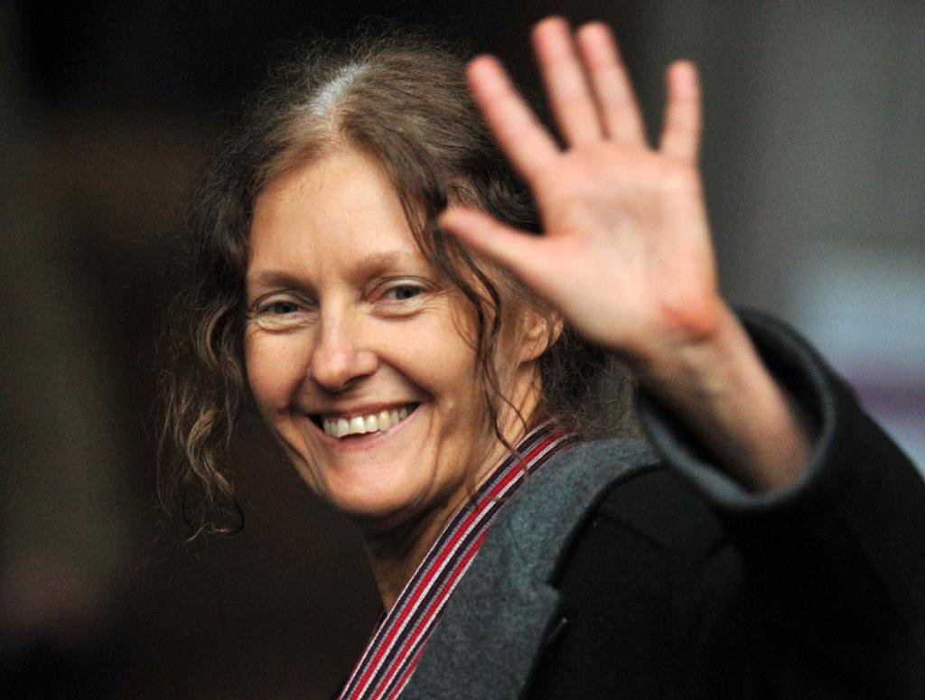 Christine Assange, mother of WikiLeaks founder, smiling and waving towards the media outside the High Court in central London.