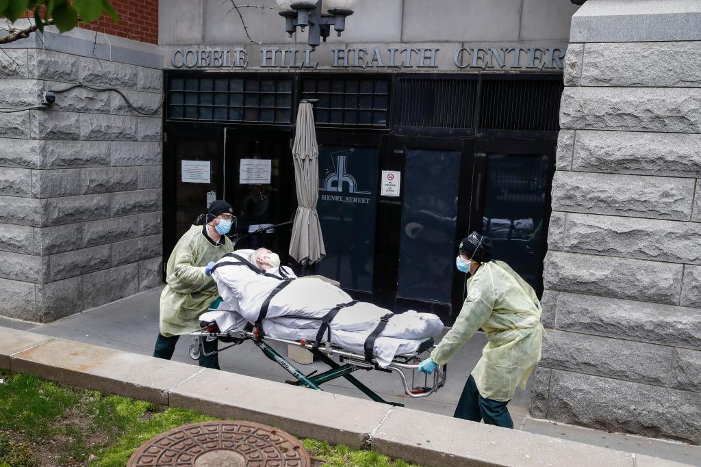 In this Friday, April 17, 2020 file photo, a patient is wheeled out of the Cobble Hill Health Center by emergency medical workers in the Brooklyn borough of New York. The facility has listed dozens of deaths linked to the COVID-19 coronavirus pandemic.