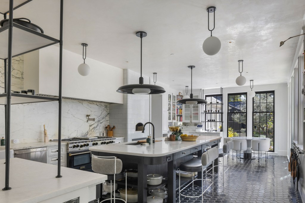 The home's supersized marble kitchen, where Paltrow frequently films herself cooking, has double cooktops and a wood-burning oven.