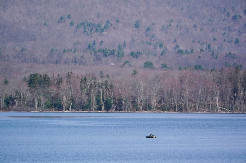 A rowboat makes its way on the surface 
