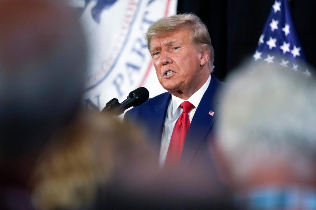 Former President Donald Trump speaking into a microphone while visiting campaign volunteers at the Elks Lodge in Cedar Rapids, Iowa.