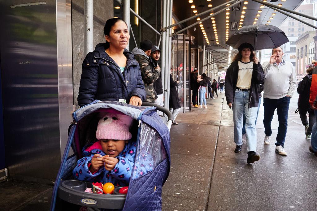 Bianca Guzman, 32, from Venezuela, and her child outside the Row NYC Hotel where they are staying  on Monday, December 18, 2023 in New York, N.Y. 